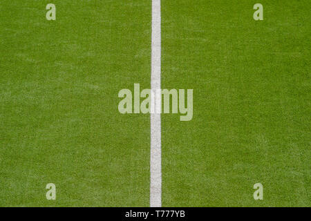 Artificial green turf texture background with white line marks Stock Photo