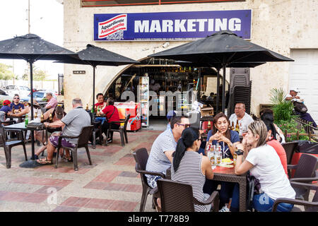 Cartagena Colombia,El Laguito,beach cafe,restaurant restaurants food dining cafe cafes,tables umbrellas,Hispanic resident residents,man men male,woman Stock Photo