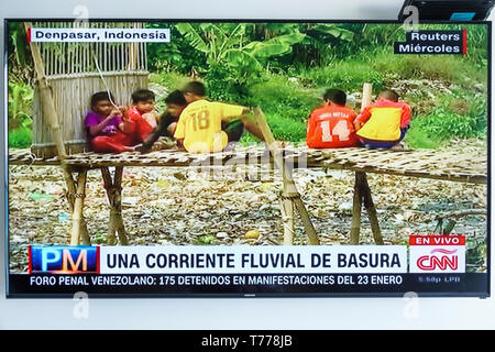 Cartagena Colombia,TV television monitor screen flat screen,Spanish language CNN,world news,Indonesia plastic garbage pollution flood tides fluvial cu Stock Photo