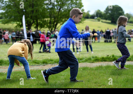 Dorset, UK. 05th May, 2019. Dorset Knob Throwing Festival, Kingston Maurward, Dorchester. Children have a go at The  Knob and Spoon Race. Credit: Finnbarr Webster/Alamy Live News Stock Photo