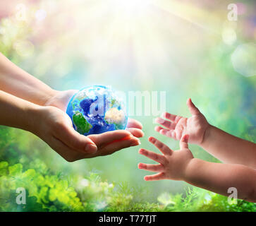 Mother Give Blue Earth In Daughter Hands - elements of this image furnished by NASA - 3d Rendering Stock Photo