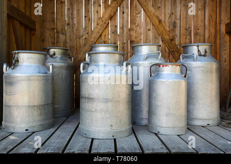 Old aluminium milk cans at dairy farm. Stock Photo