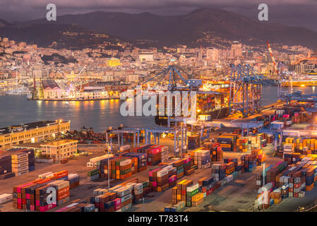 Genova, Genoa, Italy: Aerial view of shipping and container terminal, stacked containers and loading dock side cranes in the port of Genoa