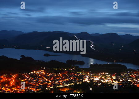 Keswick Festival of Light 2019, viewed from Latrigg looking over Keswick and Derwent Water with the path on Catbells illuminated by torchlight. Stock Photo