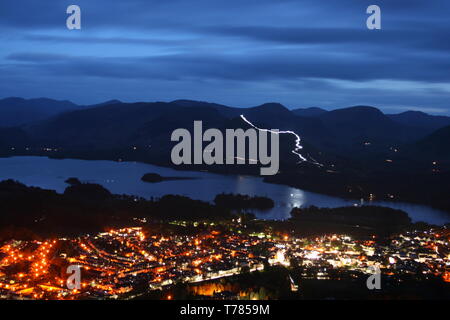 Keswick Festival of Light 2019, viewed from Latrigg looking over Keswick and Derwent Water with the path on Catbells illuminated by torchlight. Stock Photo