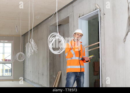 A Critical construction expert appraiser checking a constructin site Stock Photo