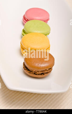 row of colorful French macaroons or macarons on a serving plate Stock Photo