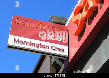 Sign for Sainsbury's Local food store at Mornington Crescent, in north London, UK Stock Photo