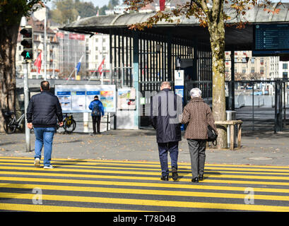 Lucerne, Switzerland - Oct 23, 2018. People walking on the street of Lucerne city along Reuss river coast (Switzerland). Stock Photo