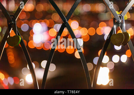 Heart shaped padlock closed on the fence Stock Photo