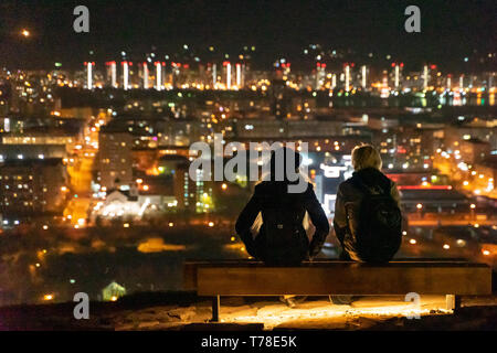 Back view of man and woman sitting on a bench Stock Photo