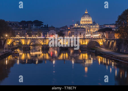 Tiber and St Peters Basilica with Aurelius Bridge or Ponte Sisto Bridge at the blue hour with lighting and reflections. Stone bridge over river Tiber Stock Photo