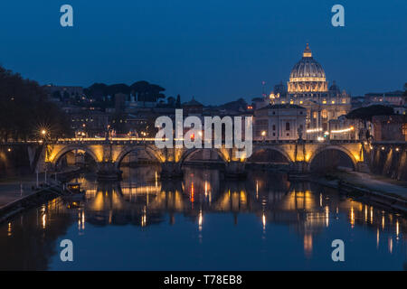 Tiber and St Peters Basilica with Aurelius Bridge or Ponte Sisto Bridge at the blue hour with artificial lighting and reflections. Stone bridge at nig Stock Photo