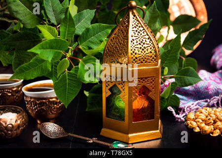 Dates served with coffee in Arabic style arrangement on a table Stock Photo