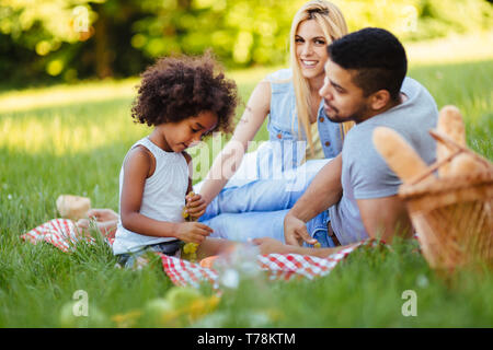 Happy family having fun time on picnic Stock Photo