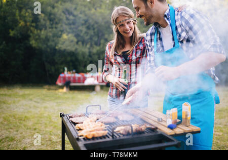 Happy friends enjoying barbecue party in nature Stock Photo
