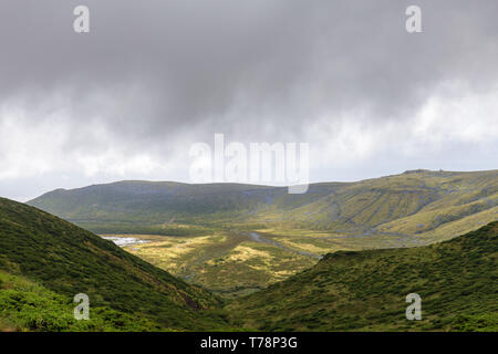 Clouds hang low over Caldeira Branca in the Reserva Florestal Natural do Morro Alto e Pico da Se, Flores. Stock Photo