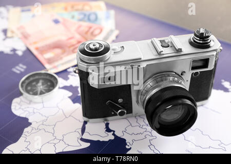 Modern camera on world map. Travel concept Stock Photo