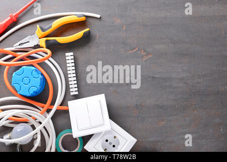 Electrician's supplies on grey background Stock Photo