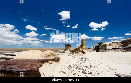 panorama rock desert landscape in northern New Mexico in the Bisti/De-Na-Zin Wilderness Area with washed out hoodoo rock formations under a blue sky Stock Photo
