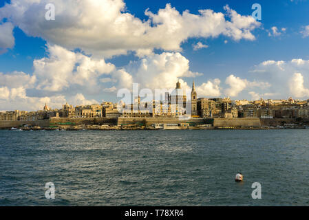 Classic postcard view to Basilica of Our Lady of Mount Carmel and St Paul's Pro-Cathedral. Valletta, Malta. Sky with beautiful clouds, sunshine Stock Photo