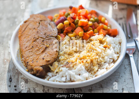 Pork roast with rice & vegetable salad Stock Photo