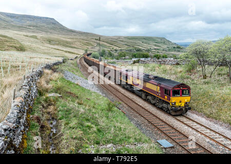 English, Welsh and Scottish heavy diesel locomotive freight train passing through Ais Gill in the Yorkshire Dales on the Settle-Carlisle railway