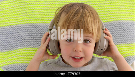 Baby in headphones Stock Photo