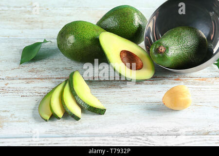 Fresh sliced avocado on wooden table Stock Photo
