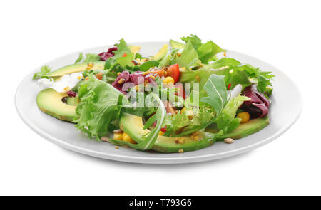 Tasty salad with ripe avocado on plate against white background Stock Photo