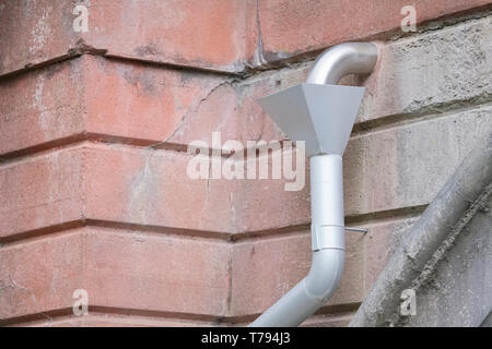 Roof wall hopper for drainage and rainwater collection external to building made of silver tin Stock Photo