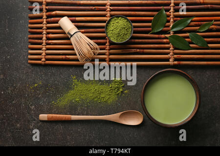 Composition with powdered matcha tea on dark grey background Stock Photo