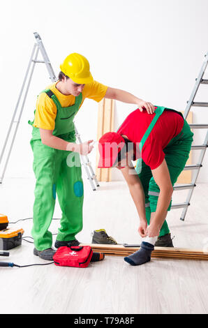 Injured worker and his workmate Stock Photo