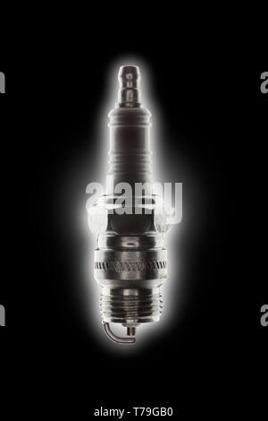 single spark plug with strong backlight glow on a black background Stock Photo