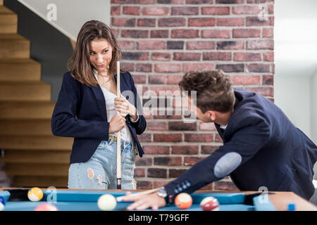 Fashionable couple playing snooker. Stock Photo