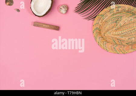 coconut, palm leaf, hat,  on a pink background, top view Stock Photo