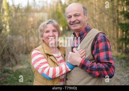 Senior woman and man walking in park Stock Photo