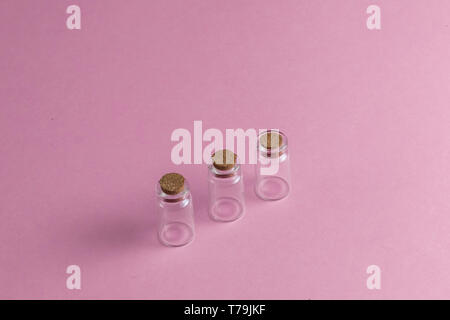 empty ampoules on the pink table. close up top view photo. copy space. three amps without powder Stock Photo