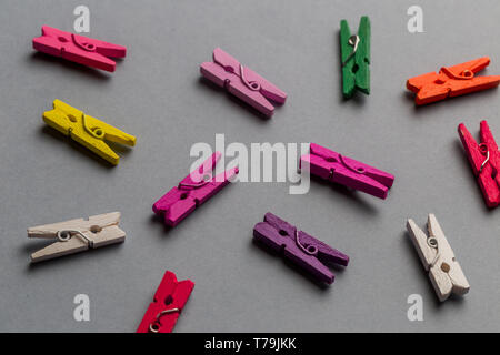 Group of wooden colorful clothespins on gray background. top view photo. Stock Photo
