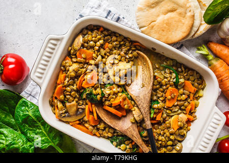 Vegan lentil curry with vegetables, top view. Healthy vegetarian food background. Stock Photo