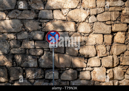 No Stopping road sign against a stone wall. Porto Portugal. Stock Photo