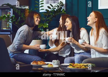 Young laughing women having tea party  Stock Photo