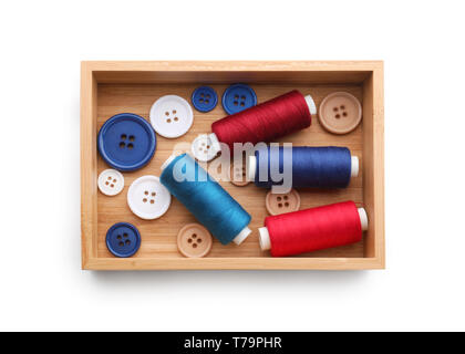 Wooden box with threads and buttons on white background Stock Photo