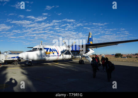 La Paz - military airport, Bolivia - May 31, 2017: An old TAM propeller airplane, boarding backpacker before departure to Rurrenabaque, Bolivia Stock Photo