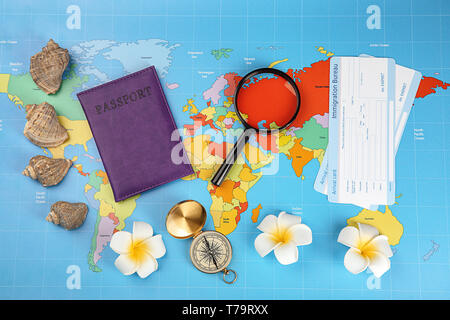 Composition with passport, immigration bureau cards and compass on world map. Travel planning concept Stock Photo