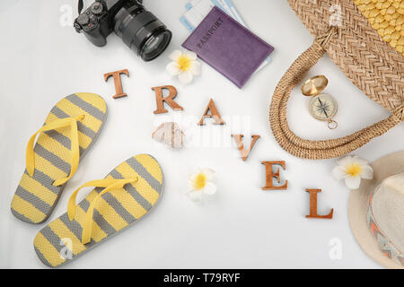 Composition with passport, photo camera, compass and word 'Travel' on white background Stock Photo