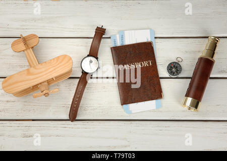 Composition with passport, airplane and compass on wooden background. Travel planning concept Stock Photo