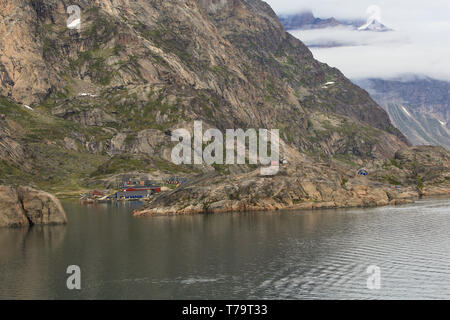 The boat harbour and buildings at Aappilattoq, a small coastal settlement along the inland waters of southern Greenland. Stock Photo