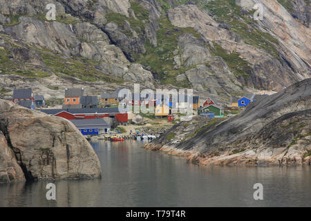 The boat harbour and buildings at Aappilattoq, a small coastal settlement along the inland waters of southern Greenland. Stock Photo