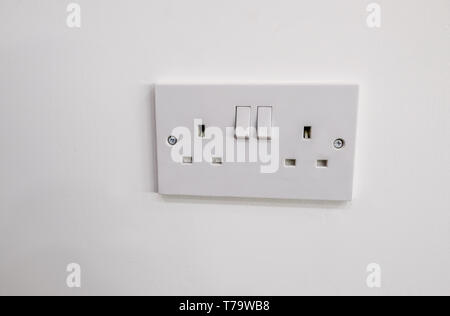 Double white plastic electric plug with two switches to turn on and off Stock Photo
